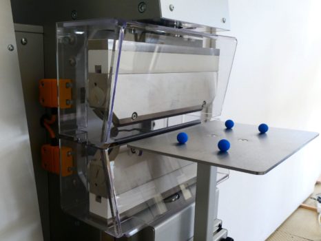 Eine Maschine mit Ablagetisch und 4 blauen Magneten